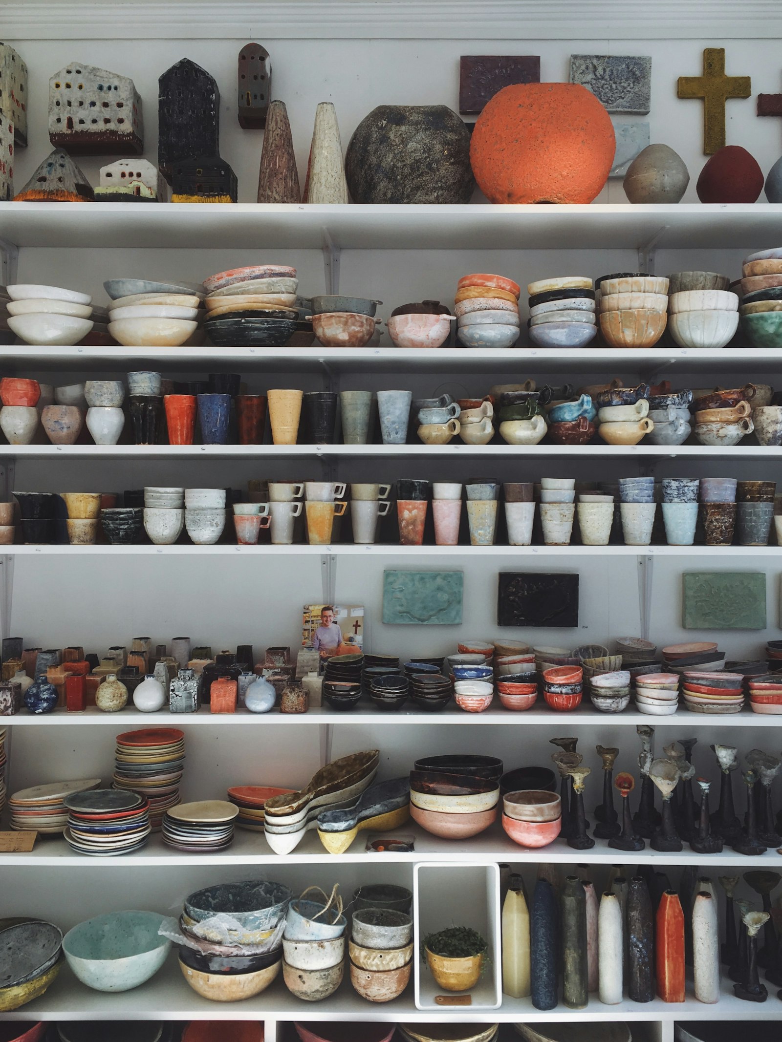 Shelves of handmade stoneware bowls, cups and vessels in many glazes (placeholder photo)